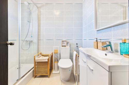 a bathroom with a toilet sink and a shower at Manelinha Apartment - cozy apartment with pool and beach in Quarteira