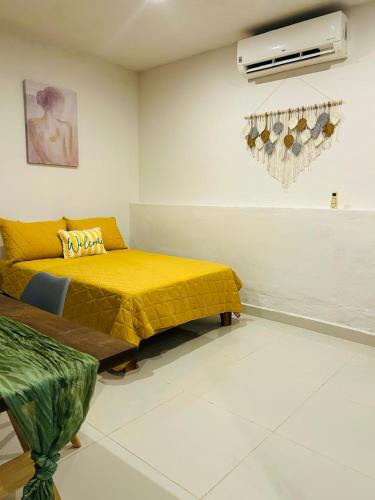 a room with a bed and a couch and a fan at Alojamiento Centrico en Chetumal in Chetumal
