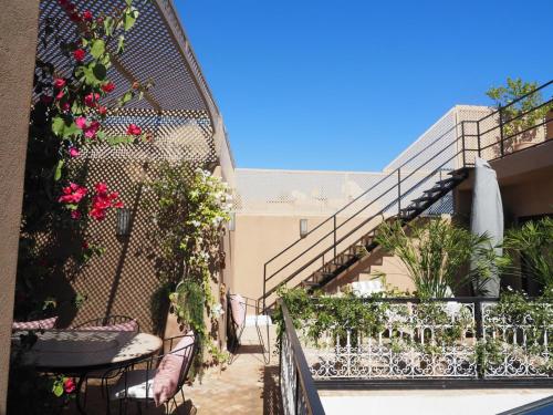 a balcony with flowers and plants on a building at Riad Kamilyes in Marrakech