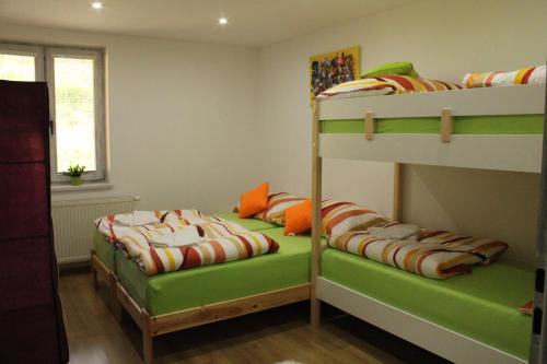 a bedroom with two bunk beds and a window at Hollandia Domasa - Nová Kelča, Prešovský kraj in Kelča