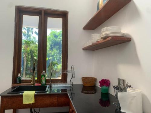 a kitchen with a sink and a window at Solaya Residence - Boutique Beach-House in Kizimkazi with Garden & Parking 