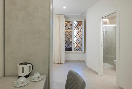 a room with a table and a chair and a window at B&B IL MORO Boutique Rooms in Siena