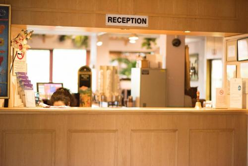 a woman sitting at the counter of a restaurant at Stay Inn Manchester in Manchester