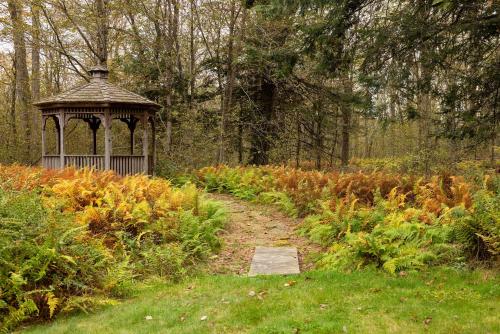 a gazebo in the middle of a garden at Private Chalet with Fire Pit Deck and Large Yard in Roscoe