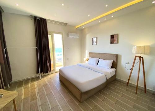 Ένα ή περισσότερα κρεβάτια σε δωμάτιο στο Alex inn Rooms