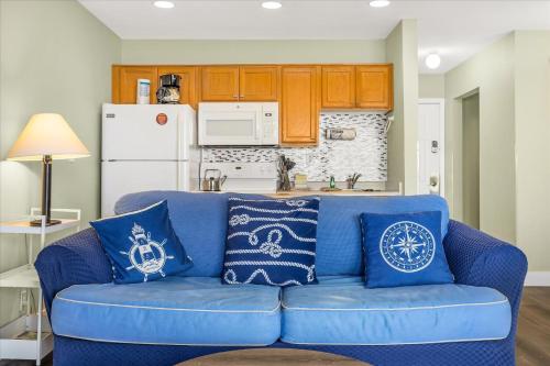 a blue couch with blue pillows on it in a kitchen at Oceanfront Studio - Ground Floor - King Bed - Easy Beach Access - Pool & Hot Tub in Lincoln City