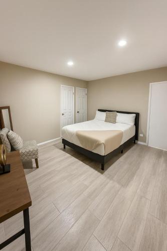 a bedroom with a bed and a chair in it at Stellarium Hotel-Valle de Guadalupe in Francisco Zarco
