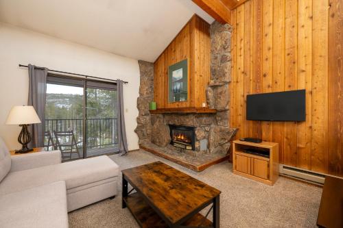 a living room with a couch and a fireplace at Beaver Village Unit #0834 in Winter Park