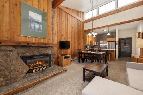 a living room with a fireplace and a dining room at Beaver Village Unit #0834 in Winter Park