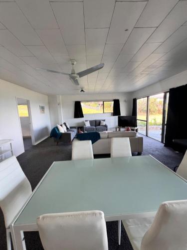 a living room with a white table and chairs at Coopers Haven- Beachfront House in Coopers Beach