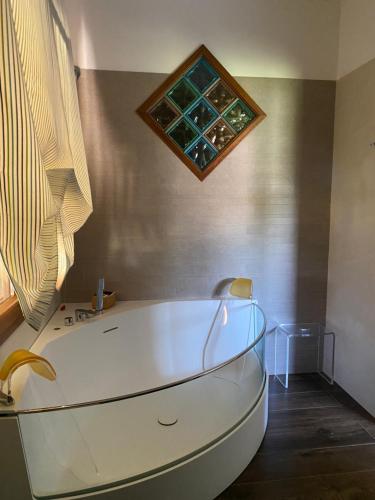 a bath tub in a bathroom with a window at Villa Culla di Jana in Alghero