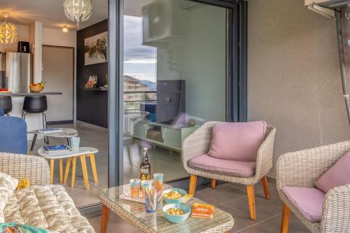 a living room with chairs and a table at Casa Pouty Beach in Bastia