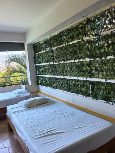 Tempat tidur dalam kamar di Bahía 50's