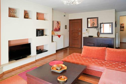 a living room with a couch and a table at Central Grevena Retreat with Mountain Views in Grevena