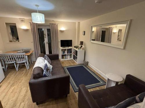 a living room with a couch and a dining room at Watchet Cottage in Watchet