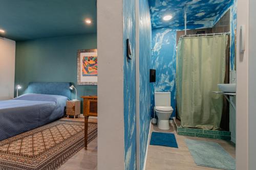 a bedroom with a bed and a sink and a toilet at The Coolest Place near the airport! in Lisbon