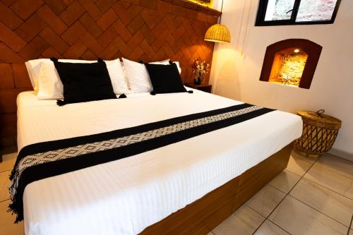 a bedroom with a large white bed in a room at Casa Sofi Oaxaca in Oaxaca City