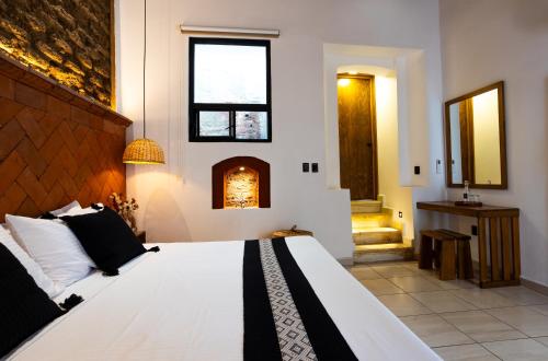 a bedroom with a large bed and a fireplace at Casa Sofi Oaxaca in Oaxaca City