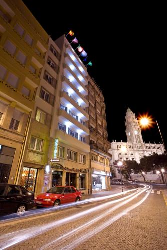 a building on a city street at night at Vera Cruz Porto Downtown Hotel in Porto