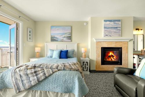 a bedroom with a bed and a fireplace at Ground Floor Queen Studio - Ocean View - Pool and Hot Tub in Lincoln City
