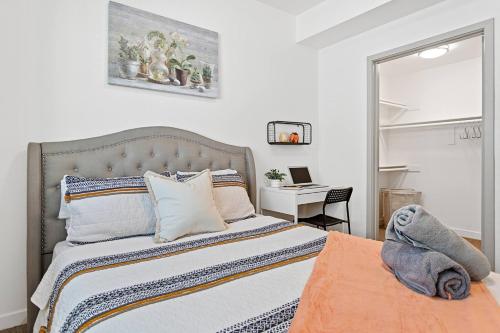 a bedroom with a bed and a desk with a laptop at Modern Room Nested In The Heart Of Orange County in Tustin