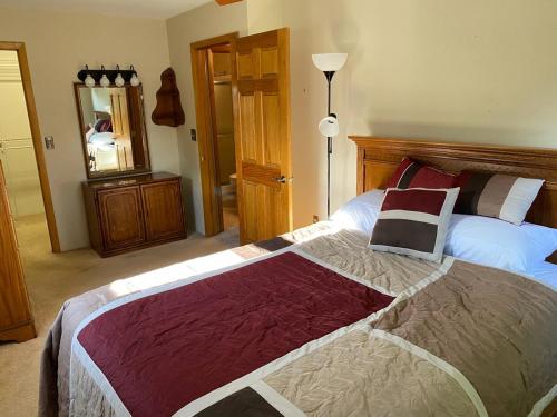 a bedroom with a large bed and a mirror at 2 bedroom home in a quiet neighborhood in Plattsburgh