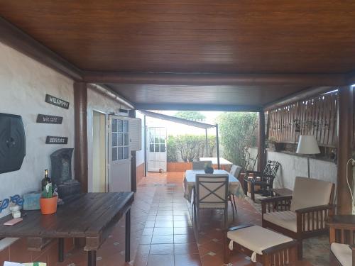 a living room with a table and a dining room at Oasis Los Porches in Playa del Ingles