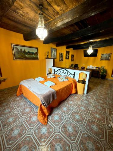a bedroom with an orange bed in a room at Casa del Ghetto in Pitigliano