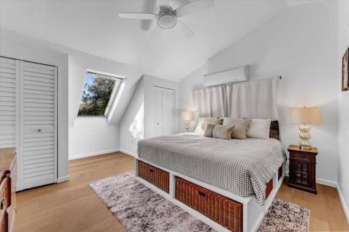 a white bedroom with a bed and a window at Montgomery Ranch - Main House in Redding