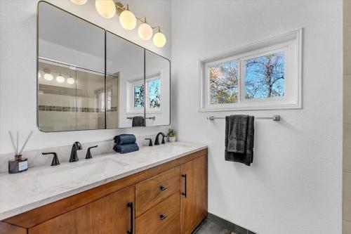 a bathroom with a sink and a large mirror at Montgomery Ranch - Main House in Redding