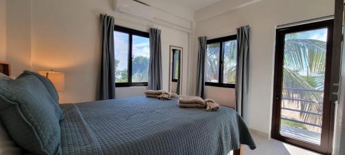 a bedroom with a bed with two towels on it at Lickety Split 2 - Northside, Oceanview Retreat in Caye Caulker
