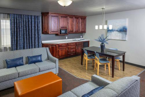 a living room with a couch and a table at Hotel J Green Bay in Green Bay