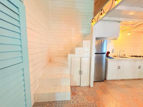 a kitchen with a refrigerator and a sink at Hotel Isabella Bacalar Lake Front in Bacalar