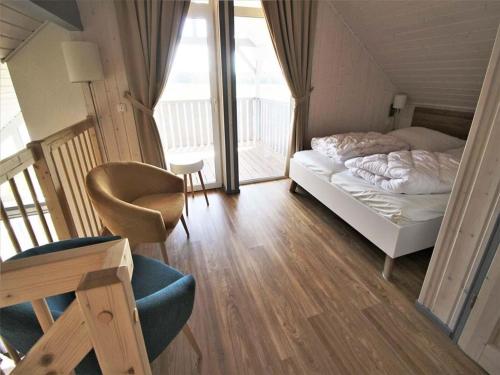 En eller flere senge i et værelse på skandinavisches Ferienhaus in Mirow