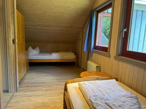 a small room with two beds and a window at exklusives skandinavisches Ferienhaus in Granzow