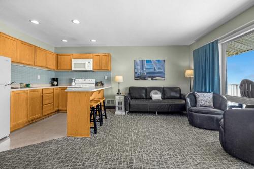 a kitchen and living room with a couch and a table at Oceanfront Family Suite - Full Kitchen - Beach Access - Pool & Hot Tub in Lincoln City