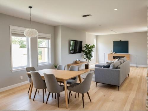 a dining room with a table and chairs and a couch at Hollywood Living 3 to 5 BR Townhomes with Free Parking in Los Angeles