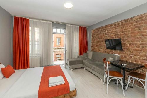 a hotel room with a bed and a brick wall at Lion Apart Hotel Taksim in Istanbul