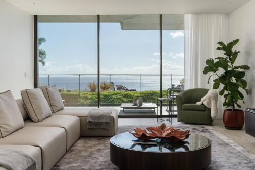 a living room with a couch and a table at Luxury Apartment at Savoy Monumentalis by An Island Apart in Funchal
