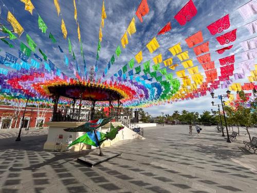 a view of a pavilion with a colorful sky at Laiva Hotel San Jose by Tasman in San José del Cabo