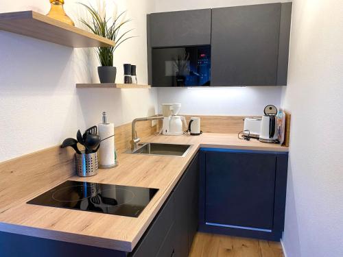 a kitchen with a sink and a counter top at Apartmenthaus Der Johanneshof - tolle Lage nah am See in Schliersee