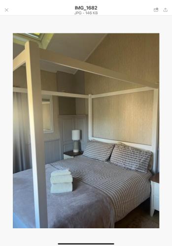 a bedroom with a bed with two towels on it at The Annex Apartment is on Cheddar Bridge Apartments in Cheddar