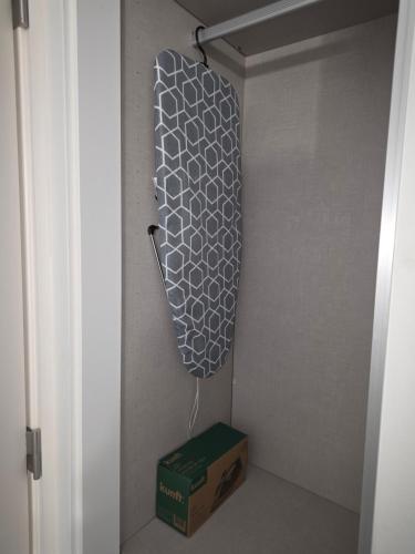 a closet with a box next to a door at 2SEA - Apartamento na praia do Ouro - Sesimbra in Sesimbra