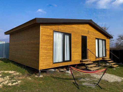 a tiny house sitting on top of a field at Tianeti Apple Cottages 
