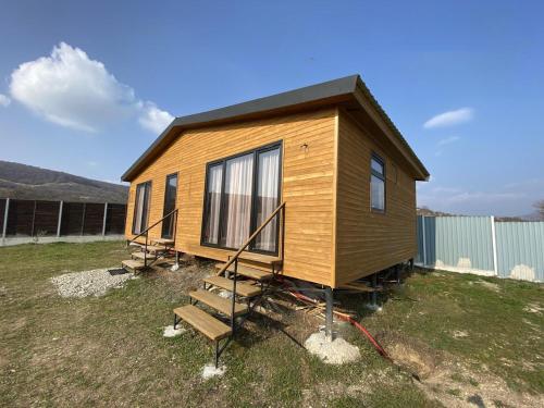 a tiny house sitting on top of a field at Tianeti Apple Cottages 