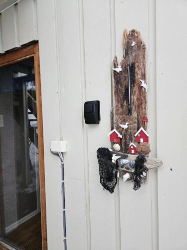 a door with a sign on the side of a building at Downtown apartment in Svolvær in Svolvær