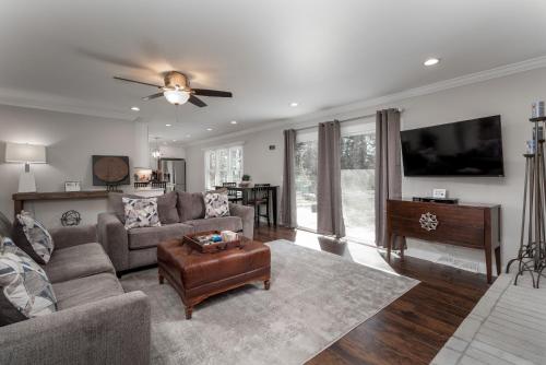 a living room with a couch and a table at Updated 2bed 2bath perfect for golfers, business travelers, and families in Greensboro
