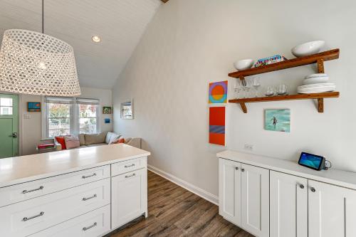 a kitchen with white cabinets and a table at Walk to Beach and Dtwn Dining! Avalon Coastal Escape in Avalon