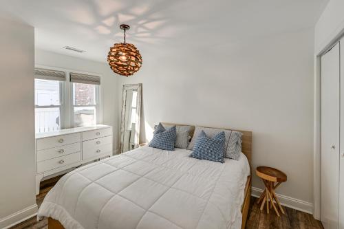 a white bedroom with a bed with blue pillows at Walk to Beach and Dtwn Dining! Avalon Coastal Escape in Avalon