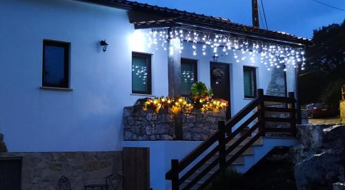 a white house with a bunch of lights on it at Casa da Pedra - Alvados Porto de Mós, Leiria in Alvados